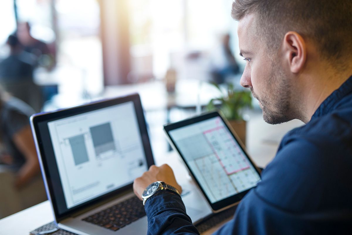 business-man-looking-analyzing-projects-his-laptop-computer-tablet.jpg